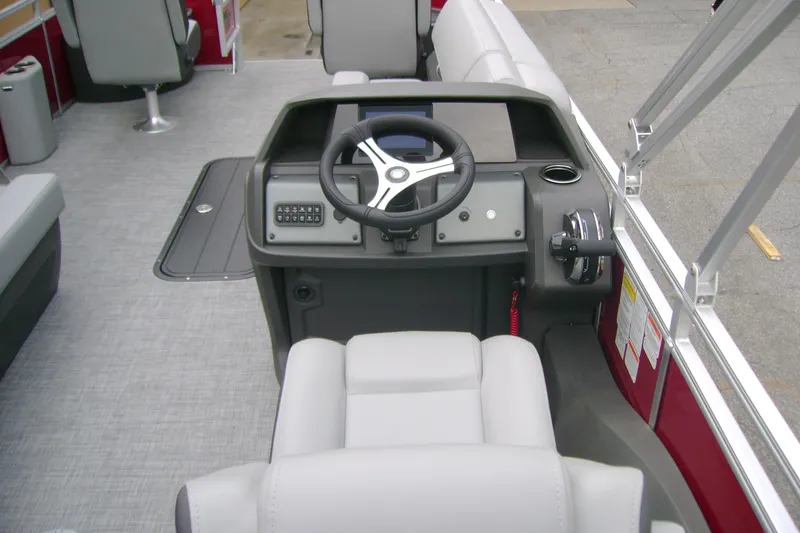 Slide: The Image of 2026 Sun Tracker Sportfish 24 XP3 boat interior with steering console and seating. - 12