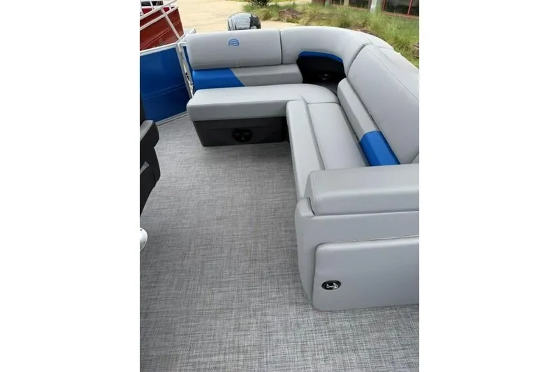 Slide: The Image of 2026 Sun Tracker Party Barge 20 DLX interior with gray and blue seating. - 17