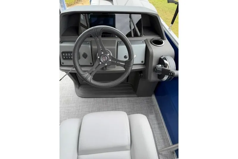 Slide: The Image of 2026 Sun Tracker Party Barge 20 DLX helm with steering wheel and controls. - 10