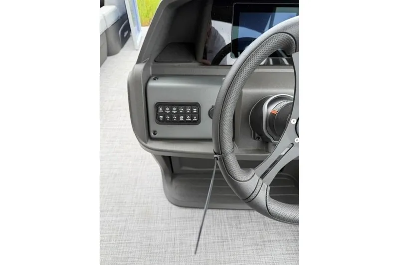Slide: The Image of Steering console of 2026 Sun Tracker Party Barge 20 DLX with control panel. - 11