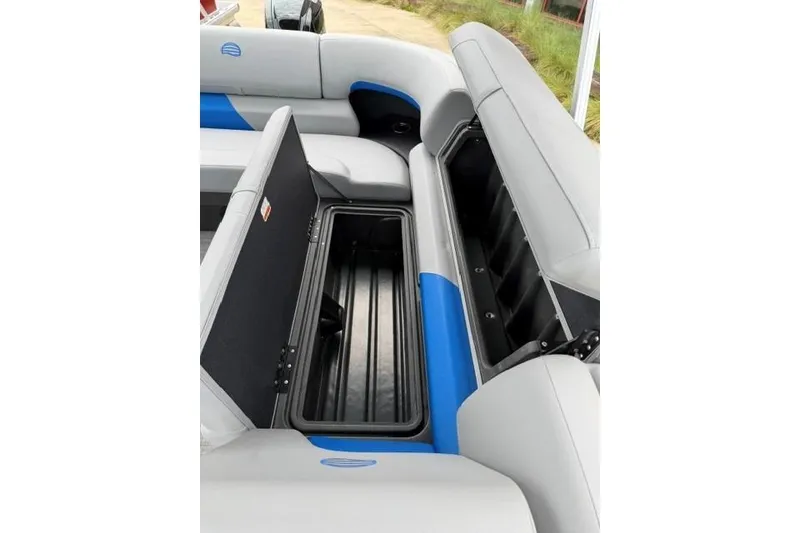 Slide: The Image of 2026 Sun Tracker Party Barge 20 DLX seating with open storage compartments. - 18