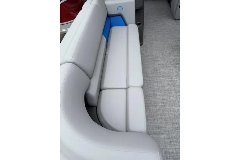 Slide: The Image of 2026 Sun Tracker Party Barge 20 DLX interior with gray seating and blue accents. - 13