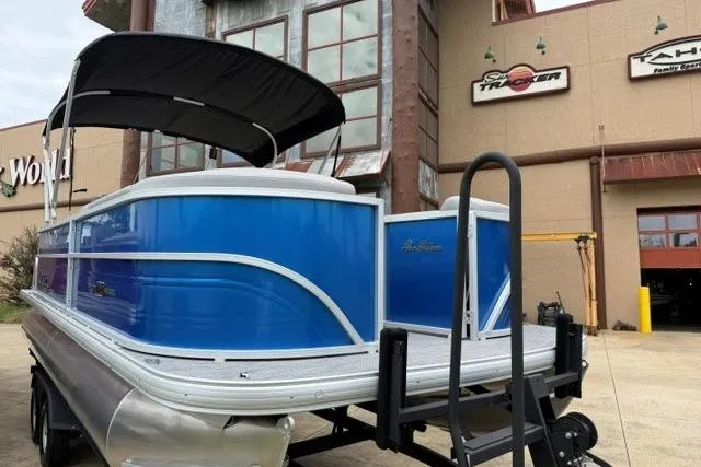 Slide: The Image of 2026 Sun Tracker Party Barge 20 DLX pontoon boat with blue exterior, displayed outdoors. - 9