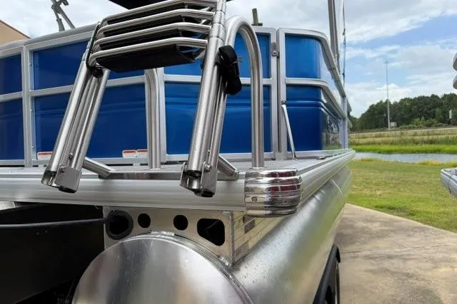 Slide: The Image of 2026 Sun Tracker Party Barge 20 DLX pontoon boat with ladder, docked outdoors. - 6