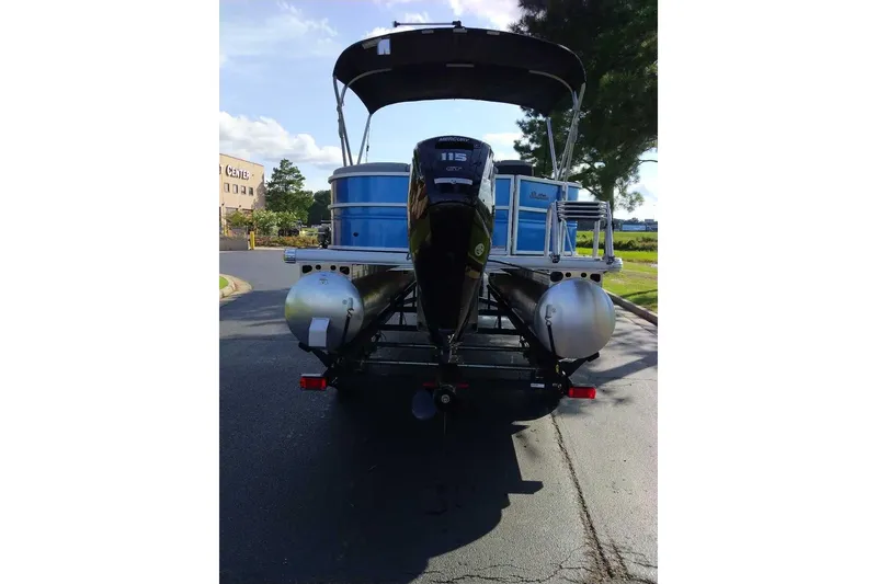 Slide: The Image of 2026 Sun Tracker Party Barge 20 DLX pontoon boat with Mercury 115 engine, rear view. - 2