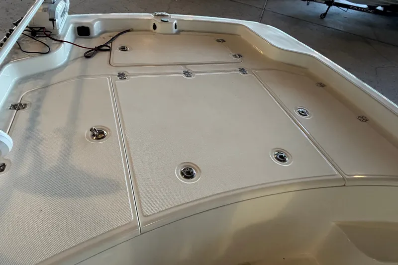Slide: The Image of 2026 Mako Pro Skiff 19 CC boat deck with storage compartments and fixtures. - 15