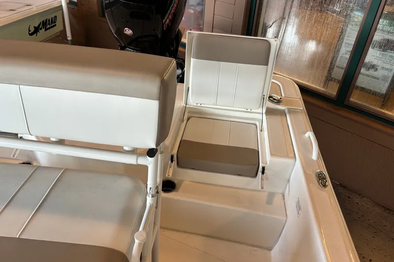 Slide: The Image of 2026 Mako Pro Skiff 19 CC boat interior with seating and storage compartments. - 14