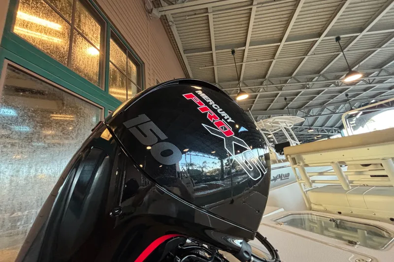 Slide: The Image of Mercury Pro XS 150 engine on 2026 Mako Pro Skiff 19 CC in a showroom. - 16