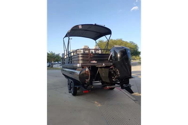 Slide: The Image of 2026 Ranger 223FC pontoon boat with canopy and powerful outboard motor on trailer. - 10