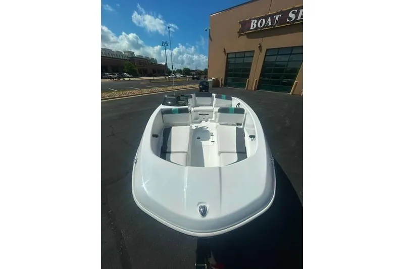 Slide: The Image of 2026 Tahoe T16 boat displayed outside a showroom under a clear blue sky. - 4