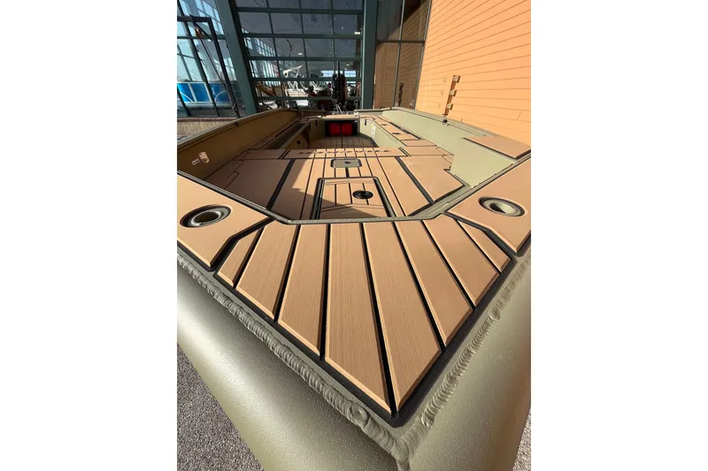Slide: The Image of 2026 Tracker Grizzly 1756 T Marsh boat interior with wood finish and cup holders. - 2