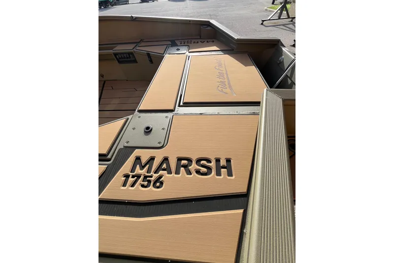 Slide: The Image of 2026 Tracker Grizzly 1756 T Marsh boat deck with "MARSH 1756" text. - 3