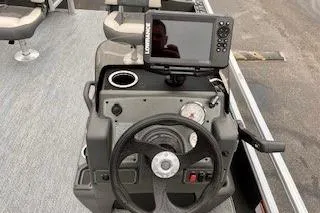 Slide: The Image of 2026 Sun Tracker Bass Buggy 18 DLX dashboard with steering wheel and fish finder. - 3