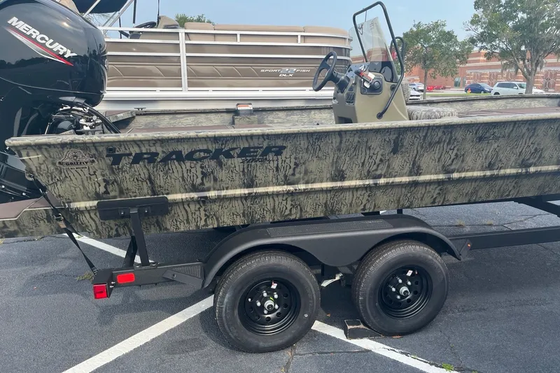 Slide: The Image of 2026 Tracker Grizzly 2072 CC boat on trailer, featuring camouflage design and Mercury engine. - 4