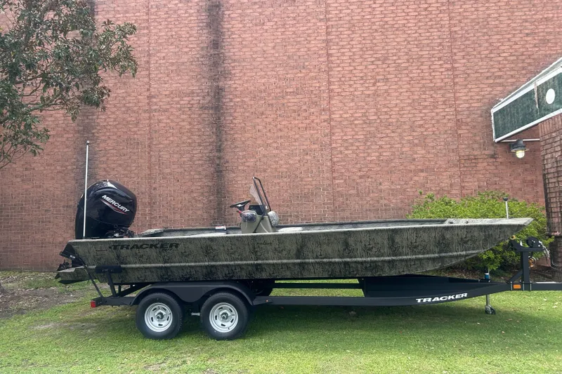 The Image of 2026 Tracker Grizzly 2072 CC boat on trailer, parked by brick wall. - 0