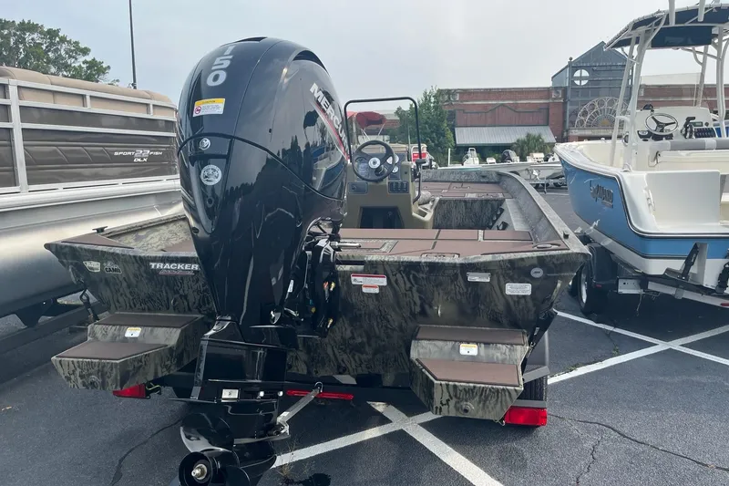 Slide: The Image of 2026 Tracker Grizzly 2072 CC boat with powerful Mercury engine, parked outdoors. - 5