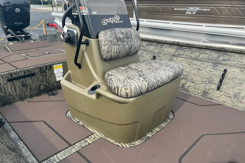 Slide: The Image of 2026 Tracker Grizzly 2072 CC boat with camo seating and steering console. - 7