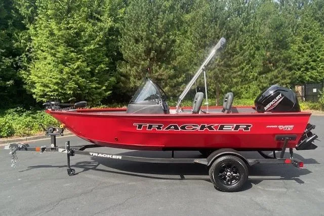 The Image of 2026 Tracker Pro Guide V-16 WT boat on trailer, red exterior, parked outdoors. - 0