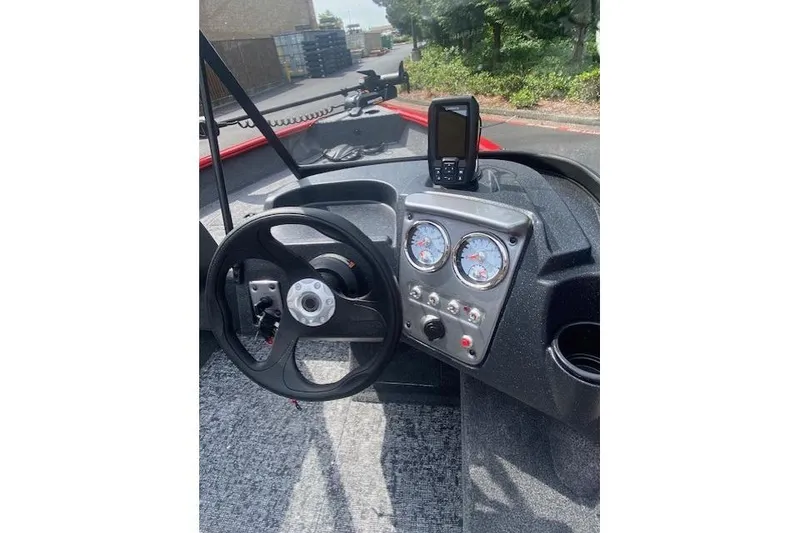 Slide: The Image of Steering console of 2026 Tracker Pro Guide V-16 WT boat with gauges and controls. - 48