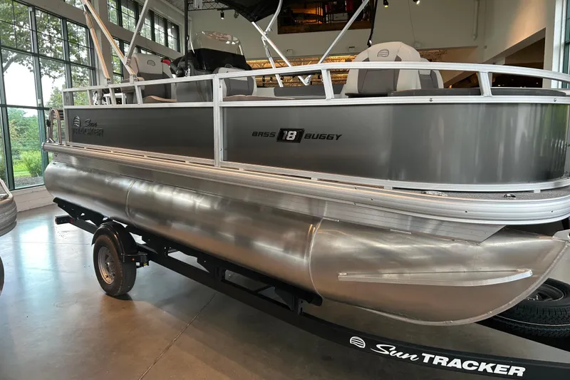 The Image of 2026 Sun Tracker Bass Buggy 18 DLX pontoon boat displayed indoors. - 0
