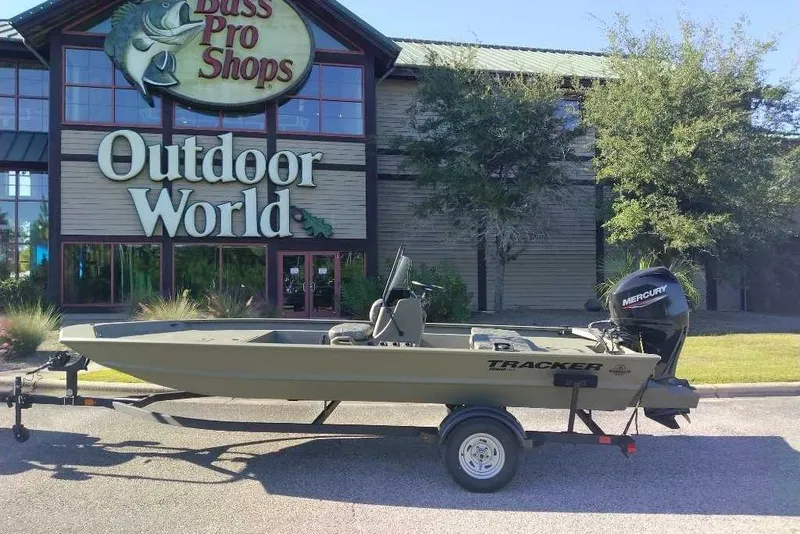 Slide: The Image of 2026 Tracker Grizzly 1860 CC boat on trailer outside Bass Pro Shops Outdoor World. - 7