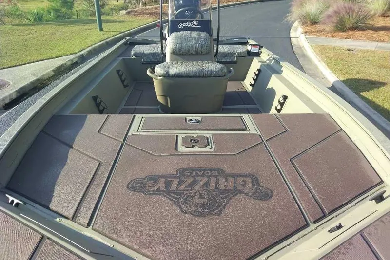 Slide: The Image of 2026 Tracker Grizzly 1860 CC boat interior with cushioned seating and spacious deck. - 4