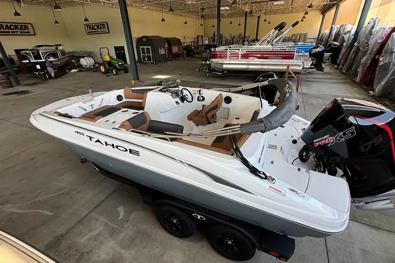 Slide: The Image of 2026 Tahoe 1950 boat in showroom, featuring sleek design and Mercury Pro XS engine. - 1