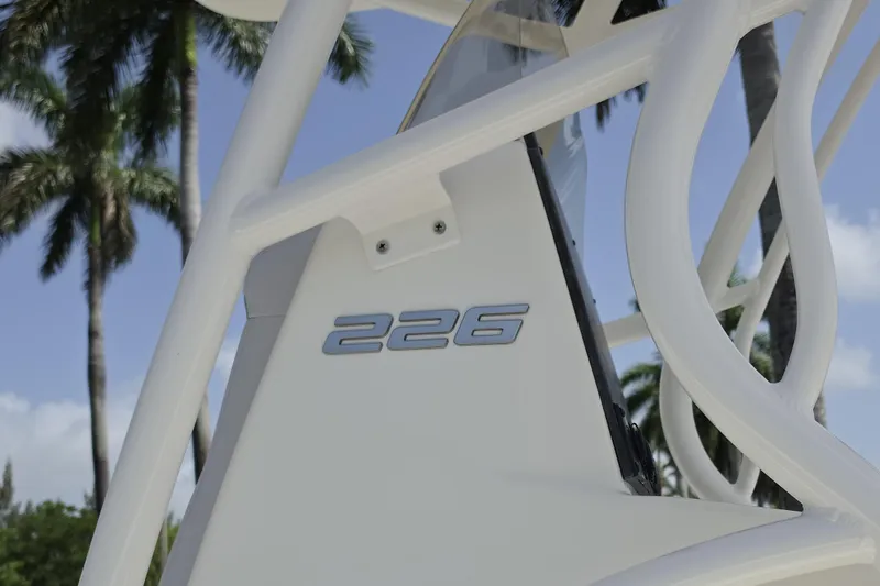 Slide: The Image of 2026 Mako 226 Center Console boat detail with palm trees in the background. - 4