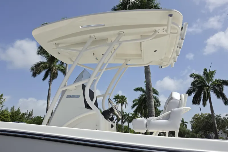 Slide: The Image of 2026 Mako 226 Center Console boat with T-top, palm trees in background. - 3
