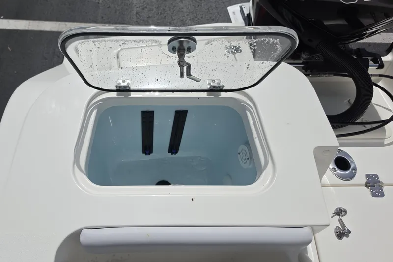 Slide: The Image of Livewell compartment on a 2026 Mako 226 Center Console boat, open lid view. - 12