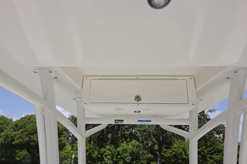 Slide: The Image of 2026 Mako 226 Center Console boat's overhead storage compartment and canopy structure. - 16
