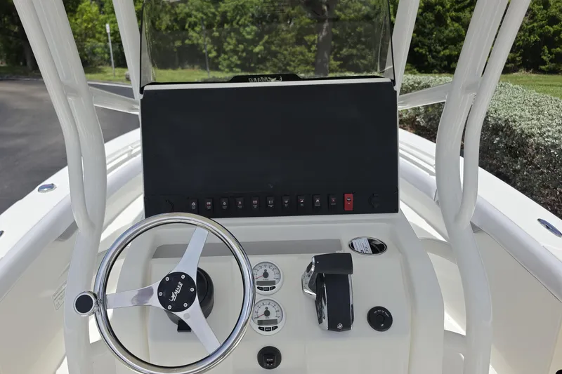 Slide: The Image of 2026 Mako 226 Center Console boat dashboard with steering wheel and controls. - 6