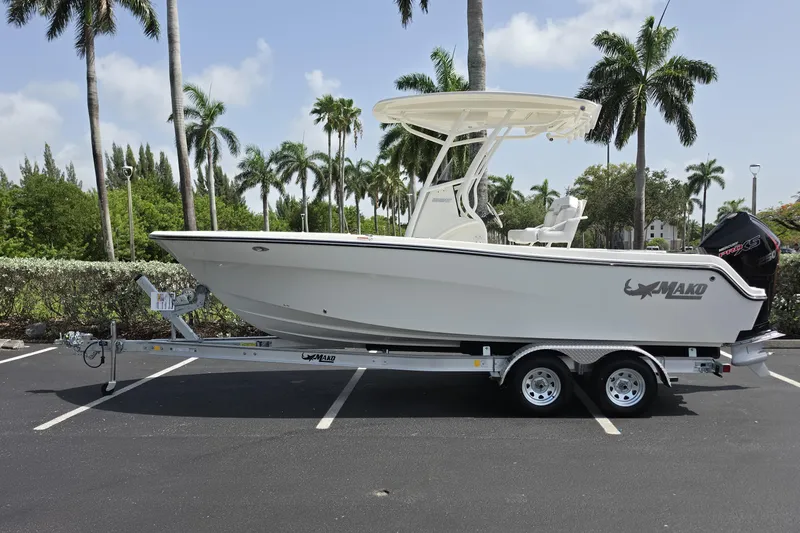 The Image of 2026 Mako 226 Center Console boat on trailer, parked with palm trees in background. - 0