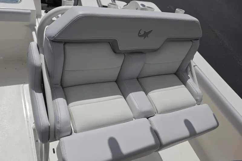 Slide: The Image of 2026 Mako 226 Center Console boat with gray cushioned seating and shark logo. - 13