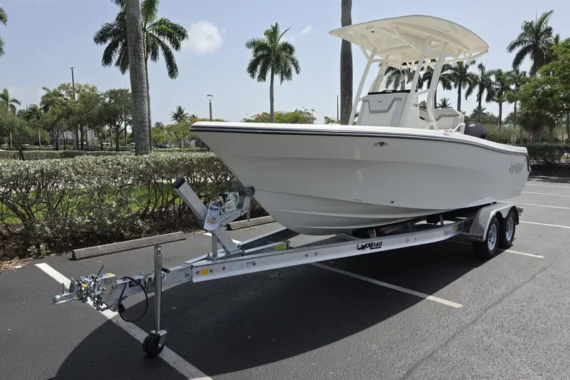 Slide: The Image of 2026 Mako 226 Center Console boat on trailer in sunny parking lot. - 2