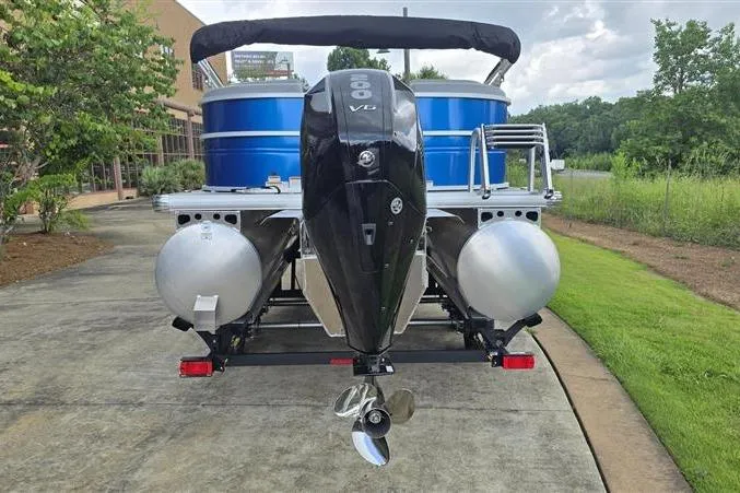 Slide: The Image of 2026 Sun Tracker Party Barge 22 XP3 pontoon boat with powerful outboard motor, parked outdoors. - 2