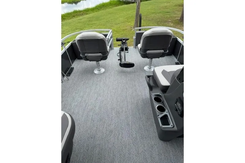 Slide: The Image of 2026 Sun Tracker Bass Buggy 18 DLX interior with seating and cup holders. - 5