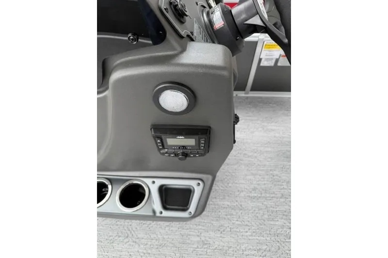 Slide: The Image of 2026 Sun Tracker Bass Buggy 18 DLX dashboard with controls and cup holders. - 9
