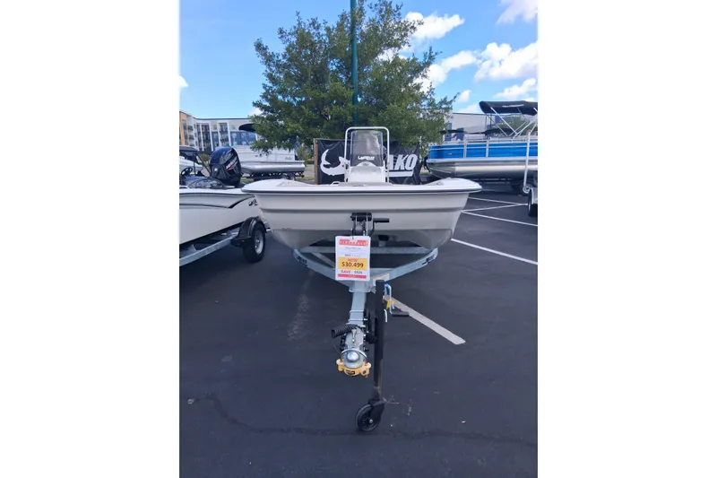 Slide: The Image of 2026 Mako Pro Skiff 17 CC boat on trailer, displayed outdoors with price tag. - 1