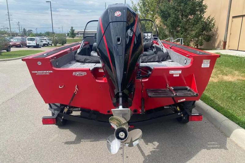 Slide: The Image of 2026 Tracker Targa V-19 Combo boat, red exterior, parked outdoors, rear view with motor. - 4