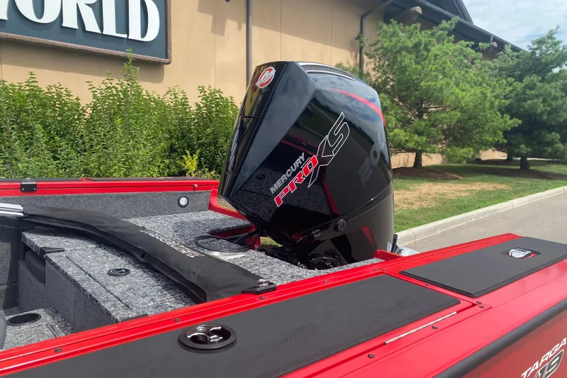 Slide: The Image of 2026 Tracker Targa V-19 Combo boat with Mercury Pro XS engine, parked outdoors. - 2