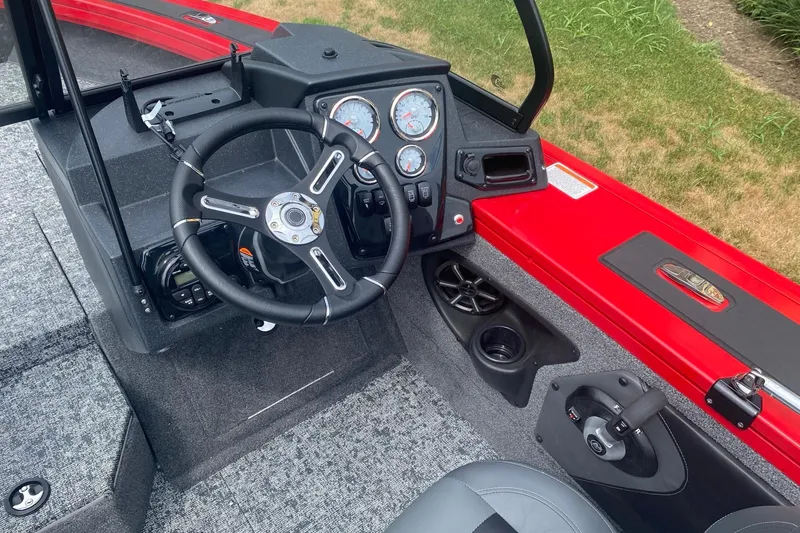 Slide: The Image of 2026 Tracker Targa V-19 Combo boat dashboard with steering wheel and control panel. - 5