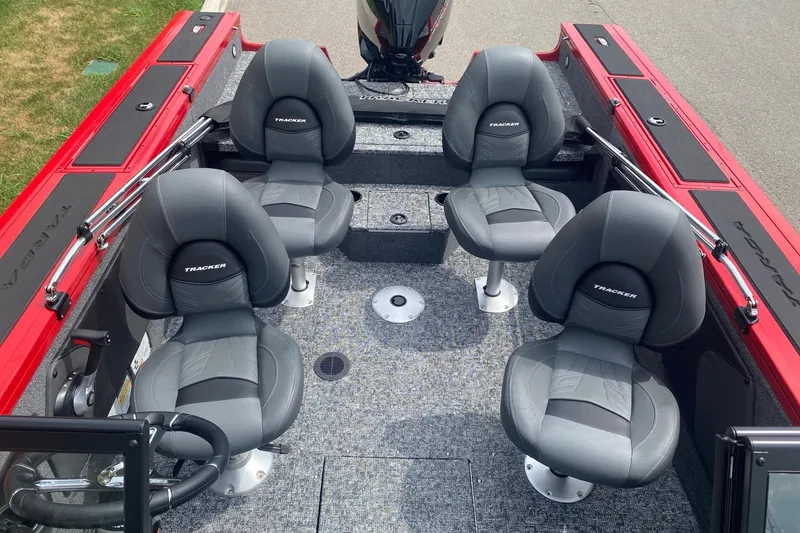 Slide: The Image of 2026 Tracker Targa V-19 Combo boat interior with four gray seats and red accents. - 8