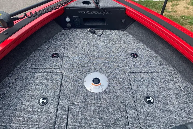 Slide: The Image of 2026 Tracker Targa V-19 Combo boat deck with gray carpet and red trim. - 7