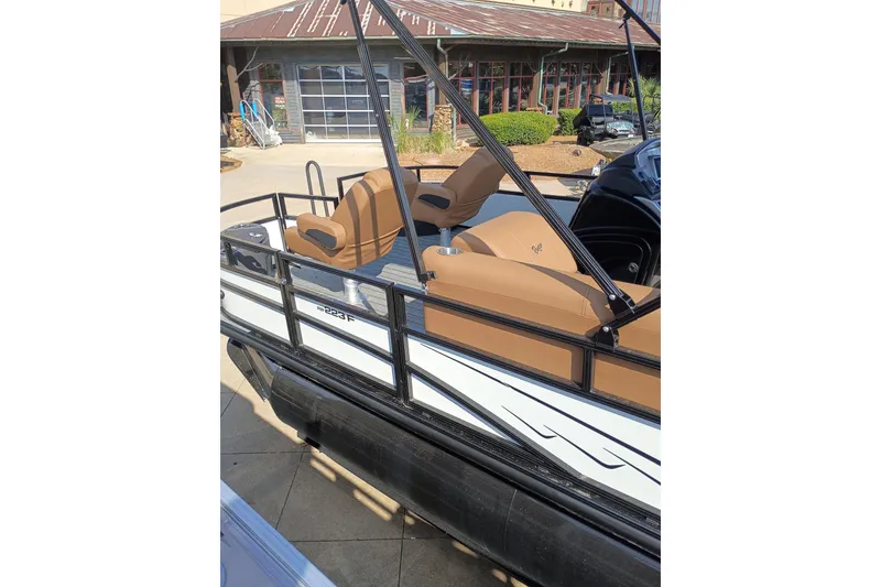Slide: The Image of 2026 Ranger 223F boat with tan seating and sleek design, docked outdoors. - 4