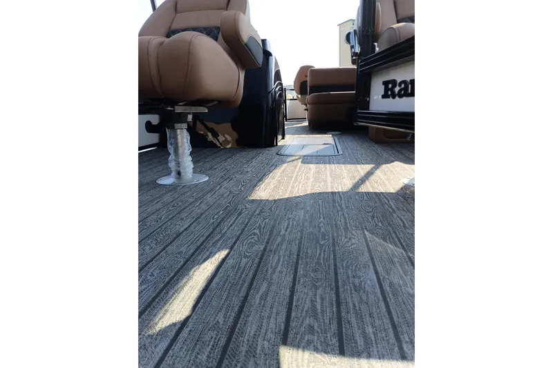 Slide: The Image of 2026 Ranger 223F boat interior with wood-textured flooring and comfortable seating. - 9