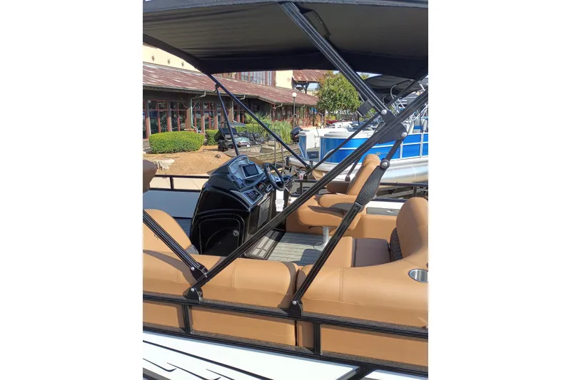 Slide: The Image of 2026 Ranger 223F boat interior with tan seating and modern dashboard. - 2