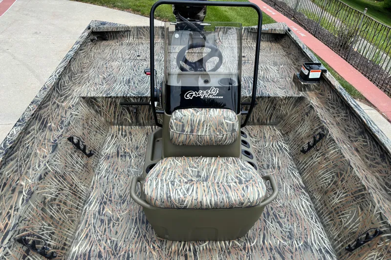 Slide: The Image of 2026 Tracker Grizzly 2072 CC boat with camouflage interior and central steering console. - 4