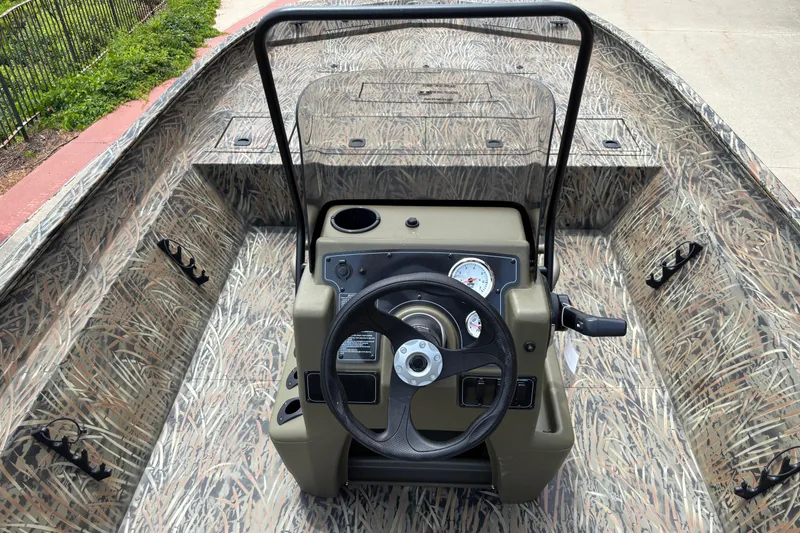 Slide: The Image of 2026 Tracker Grizzly 2072 CC boat interior with camouflage design and steering console. - 5