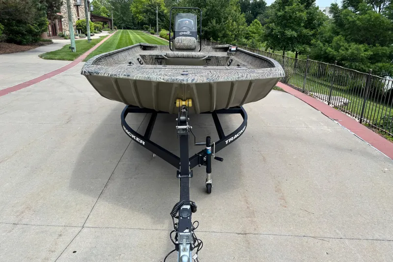 Slide: The Image of 2026 Tracker Grizzly 2072 CC boat on trailer, parked on a driveway. - 2